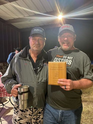 Two attendees hold the 16th Annual Doyle Boil horseshoe tournament second-place plaque.