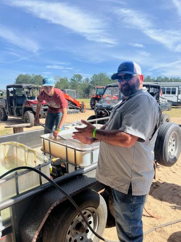 The cooking crew works beside large food preparation containers at the 2023 Doyle Boil.