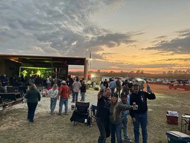 Guests gather beside the stage as the sun sets at the 2026 Doyle Boil.