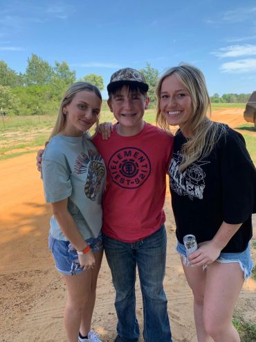 Three attendees pose together outdoors during the day at the 2024 Doyle Boil.