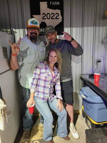 Three smiling guests pose together at the venue at the 2024 Doyle Boil.