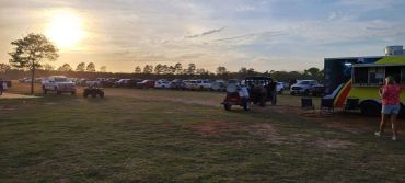 Sunset over the Doyle Boil grounds and food truck at the 2024 Doyle Boil.