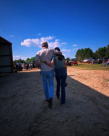 Two attendees walk together through the event grounds at the 2025 Doyle Boil.