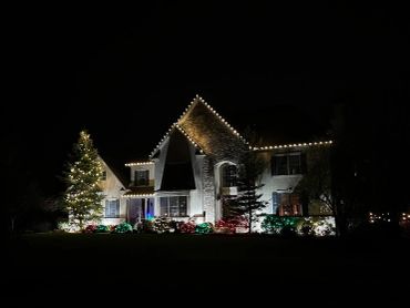 A house decorated with Christmas lights at night.