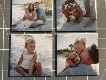 Four printed photos of a family and child at the beach.