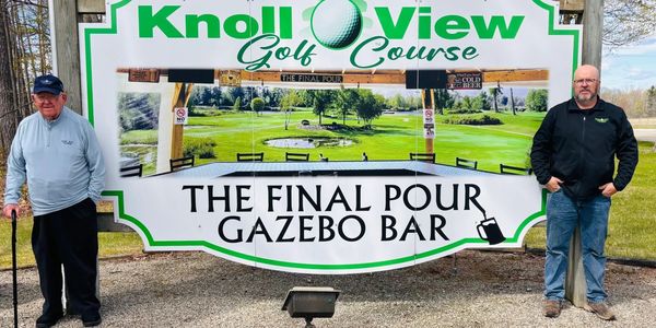 Two men stand beside a sign for Knoll View Golf Course's Final Pour Gazebo Bar.
