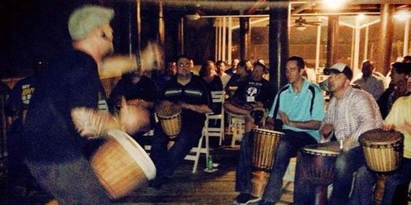 Drumming at the corporate drum circle event with the crowd