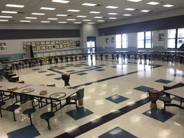 Large drum circle set-up inside at a school