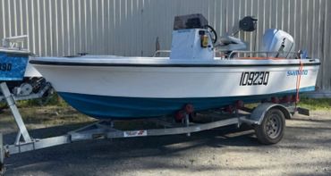 White and blue boat on a trailer with registration 109230 and Shimano branding.