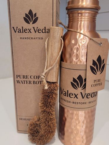 Handcrafted pure copper water bottle with cleaning brush and eco-friendly packaging.
