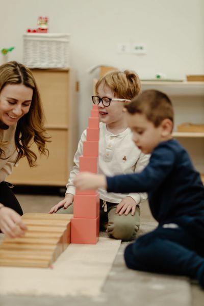 Children and a woman playing together.
