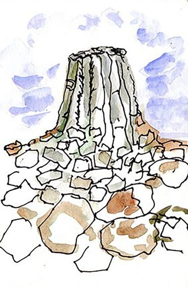 Vertical Watercolor and Ink drawing of Devils Tower rock formation with rocks leading to it and sky.