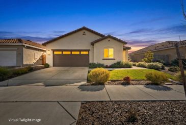 Modern single-story house with a two-car garage at twilight.
