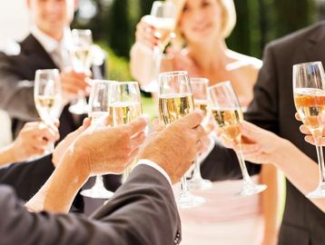 Group toasting with champagne glasses at a celebration.