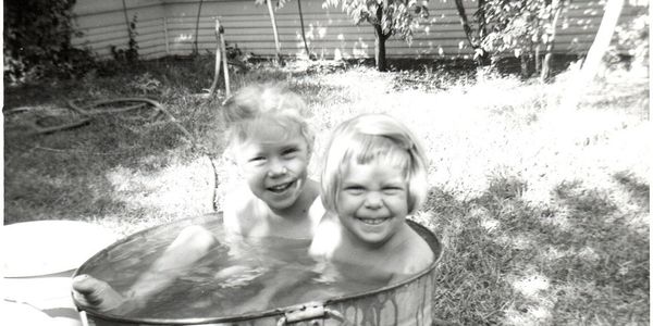 2 kids in a bucket of water