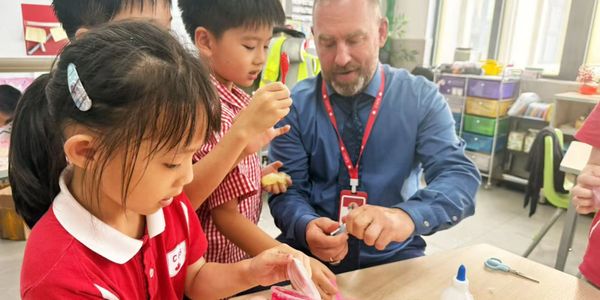 Aaron Chavez working with students in one of his international schools.