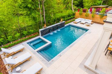Custom vinyl pool & spa. Featuring. Natural stone water feature and fire bowls
