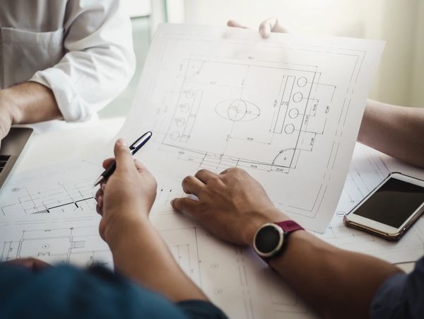 Architect or engineer team working with blueprints building plan design project in office