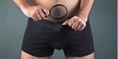 man looking at his penis size planning for penis enlargement surgery