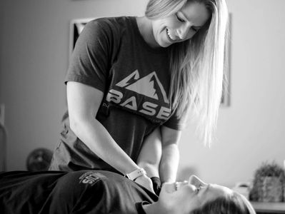 Smiling Physical Therapist in a wellness session with patient