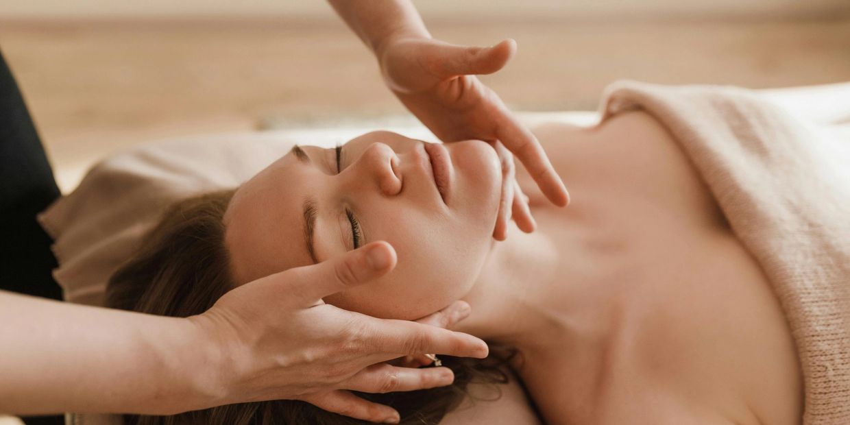 Femme recevant un massage du visage relaxant dans un spa professionnel