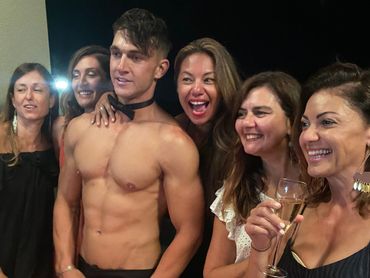 Hens party guests in Bowral posing with a Southern Highlands male stripper.