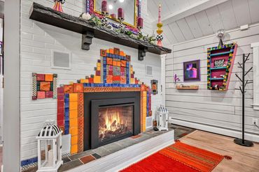 fun and colorful gas fireplace in an artists cottage available through airbnb and vrbo