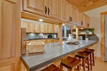 kitchen bar top with seating in a spacious vacation rental available through airbnb and vrbo