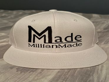 White cap with black embroidered text 'Made MillianMade'.