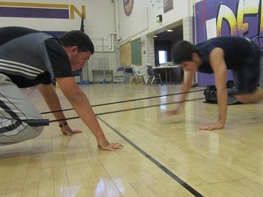 Denver fitness bootcamp class doing the Tandem Bear Holds