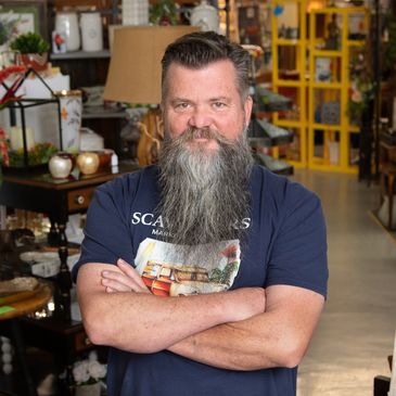 Owner Klark Kelley standing in Scavengers Marketplace SRQ