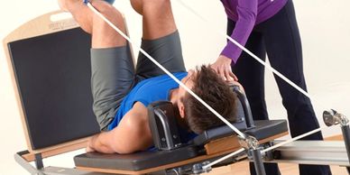 Woman helping man with exercises