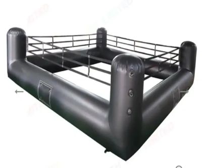 Black inflatable boxing ring with corner posts and ropes.