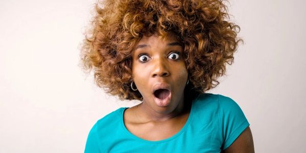 Picture of a cute girl with blue top looking surprised