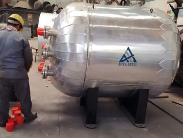 Large industrial steel tank being inspected in a workshop.