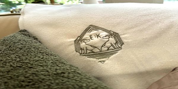Embroidered towel with animal logo.