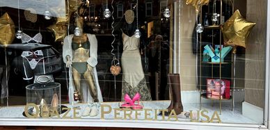 Boutique window display with lingerie and shoes.