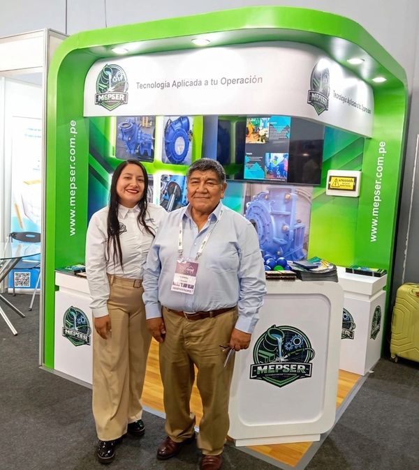 Two people standing in front of a Mepser exhibition booth at a trade show.