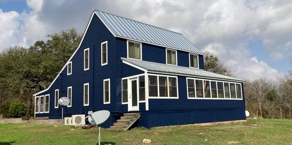 Farmhouse with Hardie Colonial Roughsawn lap siding and Hardie Trim.