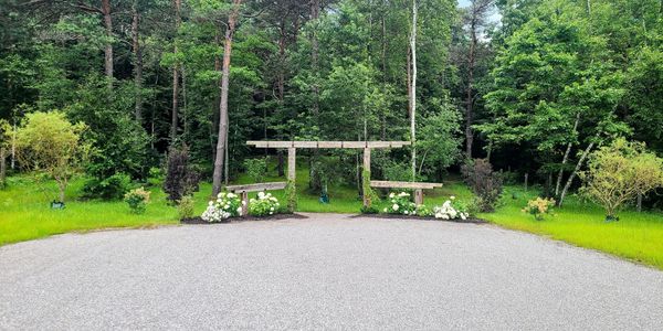 A peaceful park bench area surrounded by greenery and flowers.