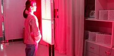 Standing in front of wavelength red Light panel for its benefits