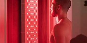 Standing in front of wavelength red Light panel for its benefits