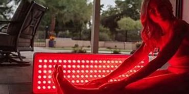 Sitting in front of wavelength red Light panel therapy