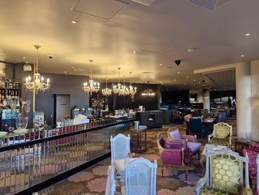 Elegant restaurant interior with vintage chairs and crystal chandeliers.