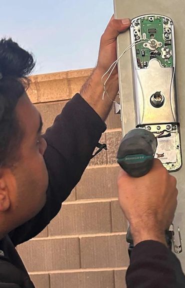 Door lock repairs. Technician working on it