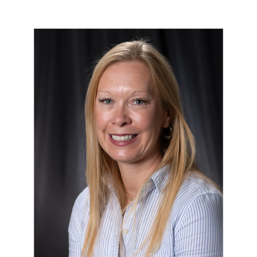 Smiling woman with long blonde hair in a striped shirt.