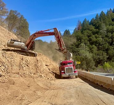 dump truck getting loaded with dirt