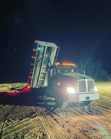 grey dump truck with dump bed up