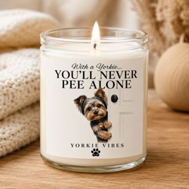 Lit candle with a Yorkie dog and humorous text.