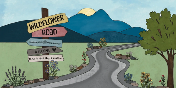 Illustration of a winding country road with welcoming wildflower signs and distant mountains.